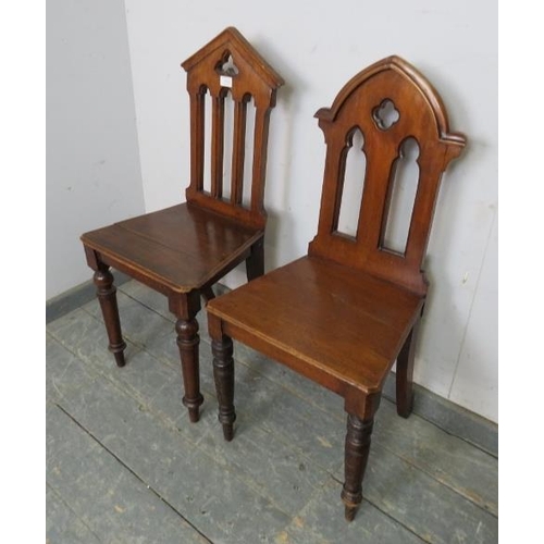 808 - A pair of 19th century mahogany his and hers hall chairs, having carved and pierced backs, on turned... 