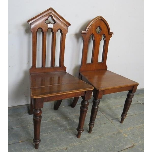 808 - A pair of 19th century mahogany his and hers hall chairs, having carved and pierced backs, on turned... 