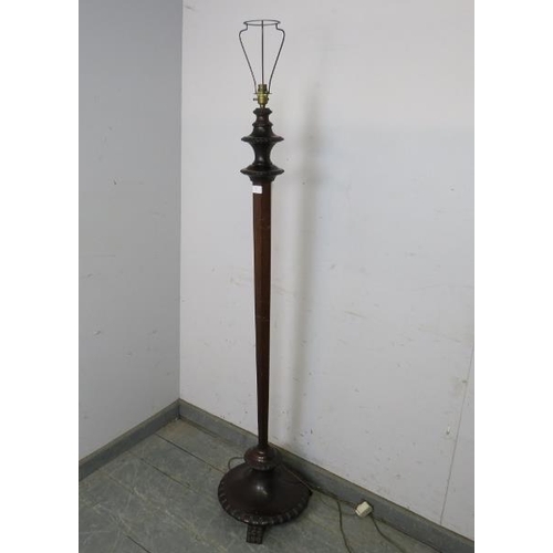 811 - A vintage mahogany standard lamp, on a tapered hexagonal column, the carved plinth base with hairy p... 