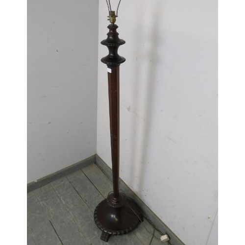 811 - A vintage mahogany standard lamp, on a tapered hexagonal column, the carved plinth base with hairy p... 