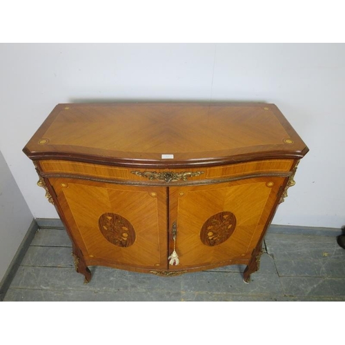 827 - A vintage French walnut and tulipwood serpentine fronted side cabinet in the 19th century taste, hav... 