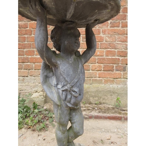 841 - A vintage lead water fountain in the Georgian taste, modelled as Putti holding aloft a scalloped dis... 