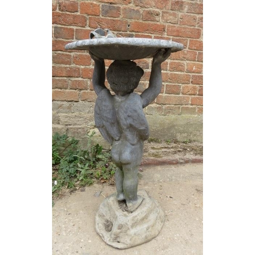 841 - A vintage lead water fountain in the Georgian taste, modelled as Putti holding aloft a scalloped dis... 