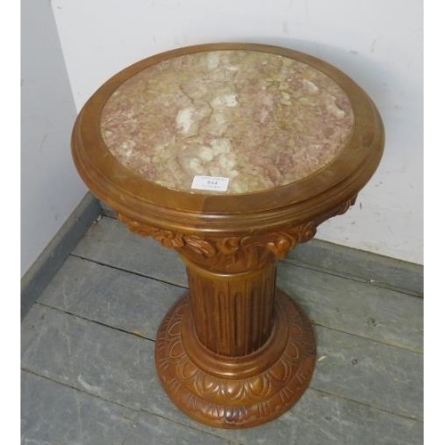 844 - A carved hardwood plantstand in the form of a Corinthian column with rouge marble insert. 
H61cm Dia... 