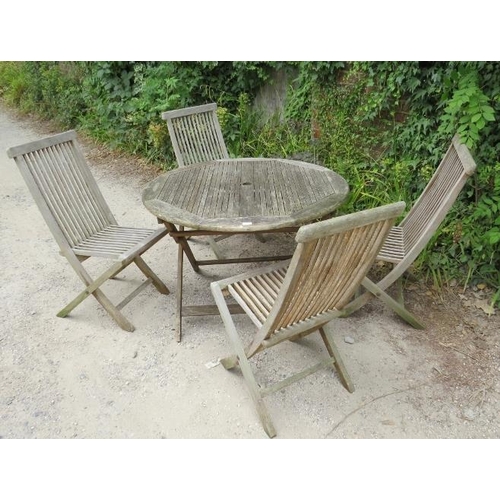 849 - A weathered teak garden set, comprising a circular table, together with four folding chairs. 
Condit... 