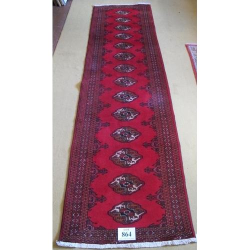 864 - North East Persian Turkoman runner.  14 repeat patter medallions on a deep red ground.  280cm x 80cm... 