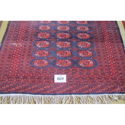 869 - A Persian Bokhara rug with a central repeat pattern on blue ground.  200cm x 129cm (approx)  Conditi... 