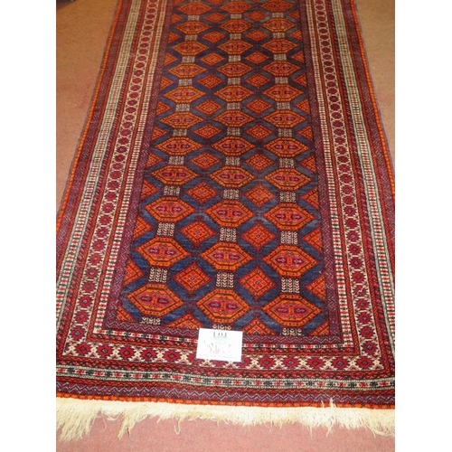 874 - A 20th century Persian rug, central field of repeat pattern, orange/red on blue ground. 180cm x 96cm... 