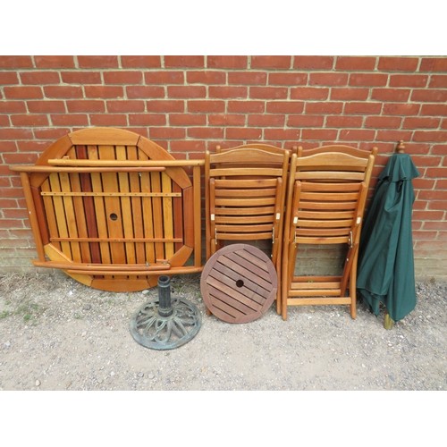 850 - A teak garden set, comprising a circular folding table and four folding garden chairs, together with... 