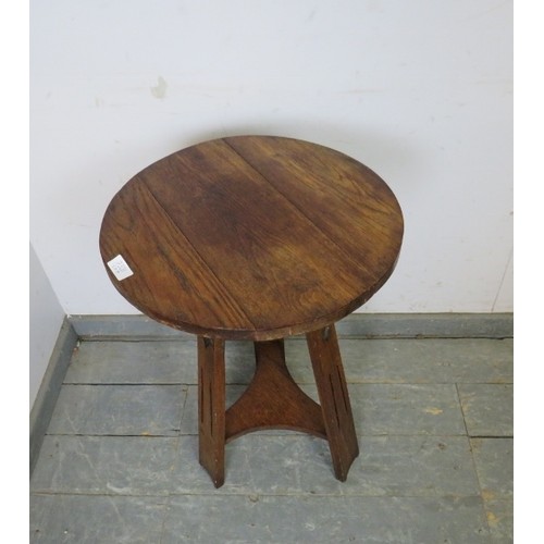 730A - An Arts & Crafts Period solid oak occasional table in the manner of Liberty's, the circular top on c... 