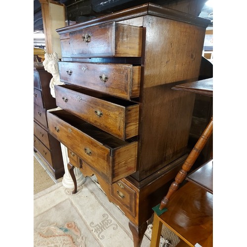 764 - An early Georgian medium oak and walnut chest on stand, the top housing two short and three long gra... 