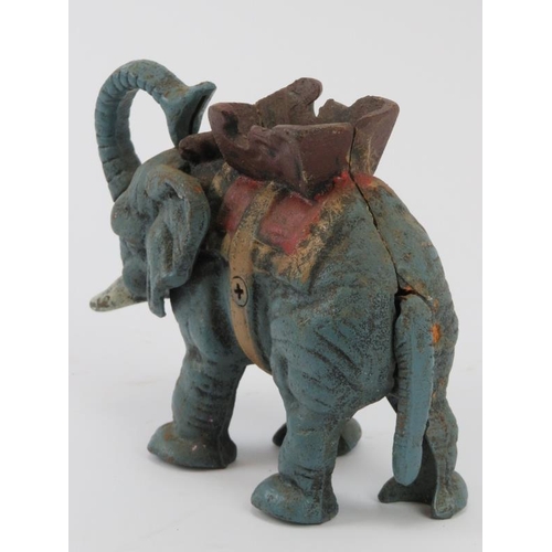 15 - An American vintage novelty cold painted cast iron mechanical elephant money bank. Modelled with a m... 