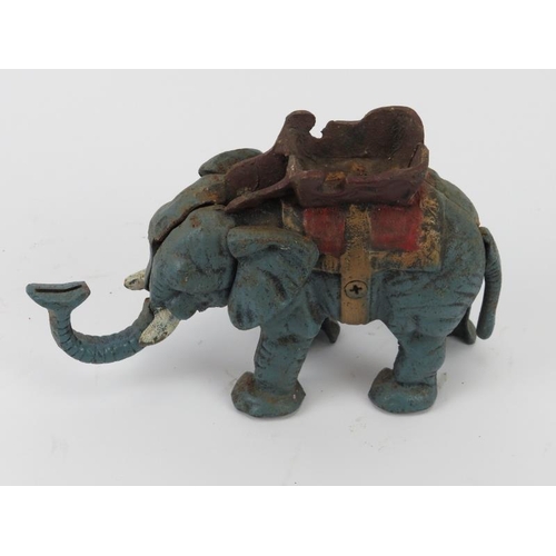 15 - An American vintage novelty cold painted cast iron mechanical elephant money bank. Modelled with a m... 