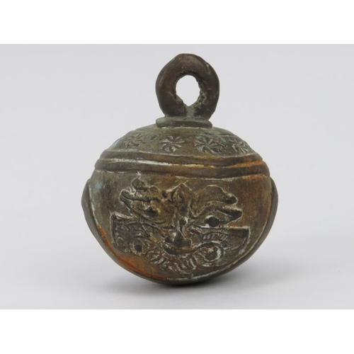 19 - A Burmese bronze buffalo bell, 19th century. Similar in form to a crotal bell, decorated with masks ... 