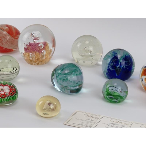 33 - A collection of vintage glass paperweights. Comprising seventeen glass paperweights and a resin pape... 