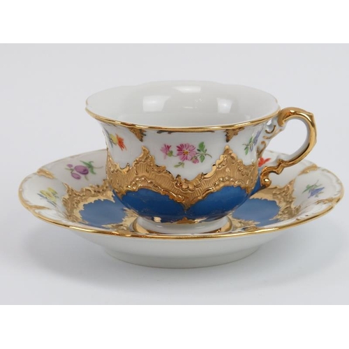 34 - Eight Meissen porcelain tea cups and saucers, 20th century. Gilt blue and white porcelain hand paint... 