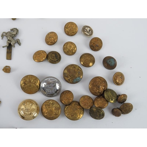 37 - Militaria: A collection of mainly WWI and WWII period British military cap badges, buttons and relat... 