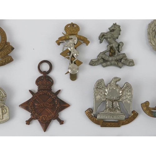 37 - Militaria: A collection of mainly WWI and WWII period British military cap badges, buttons and relat... 