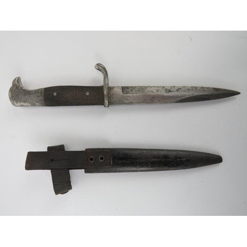 46 - A WWII German knife by Carl Eickhorn. With eagle head pommel and blade with Eickhorn mark housed in ... 