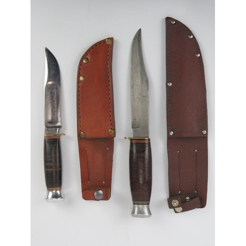 47 - Two vintage British knives, circa 1940s/50s. Both with stacked leather handles and housed in leather... 