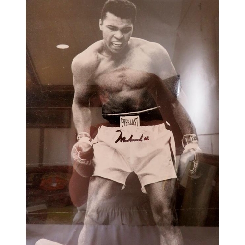 553 - Muhammad Ali Memorabilia. Framed and glazed enlarged photograph, signed by Muhammad Ali, with certif... 