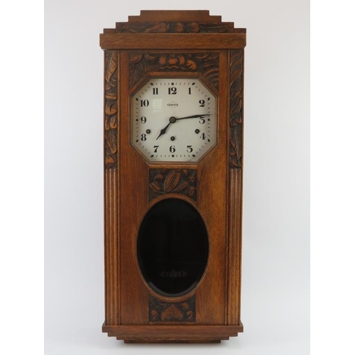 91 - A French Vedette carved oak Westminster chiming wall clock, early 20th century. 80.5 cm height, 33.8... 