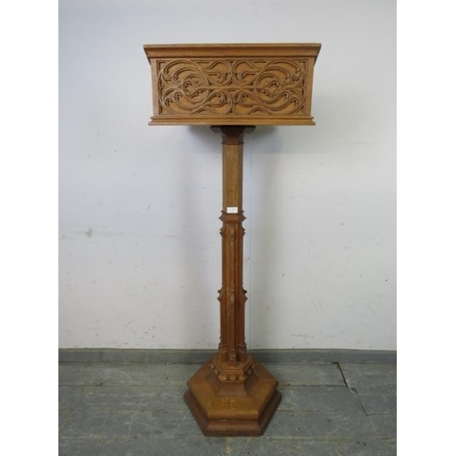 702 - A vintage light oak lectern in the Gothic taste, the book rest with well carved blind fretwork decor... 