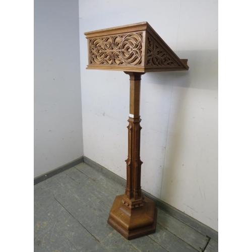 702 - A vintage light oak lectern in the Gothic taste, the book rest with well carved blind fretwork decor... 