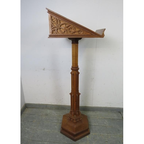 702 - A vintage light oak lectern in the Gothic taste, the book rest with well carved blind fretwork decor... 