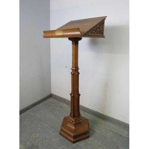 702 - A vintage light oak lectern in the Gothic taste, the book rest with well carved blind fretwork decor... 