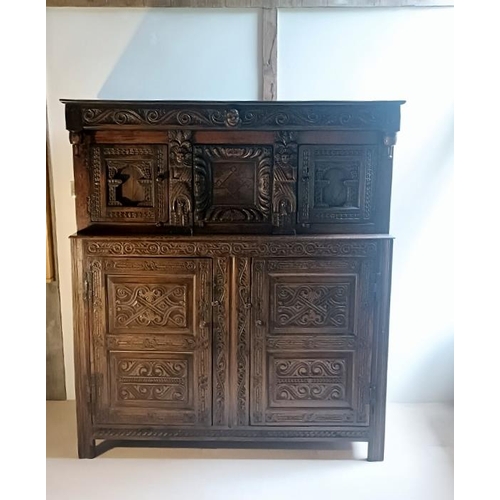 704 - A 17th century oak court cupboard of good colour and proportions, the scroll carved frieze with cent... 