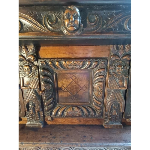 704 - A 17th century oak court cupboard of good colour and proportions, the scroll carved frieze with cent... 