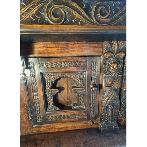 704 - A 17th century oak court cupboard of good colour and proportions, the scroll carved frieze with cent... 