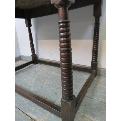 705 - A 17th century oak side table of good colour, the planked top above a plain frieze, on unusual taper... 