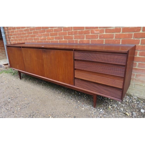 710 - A mid-century solid Afromosia teak sideboard by Richard Hornby for Heal’s, housing three cupboards w... 