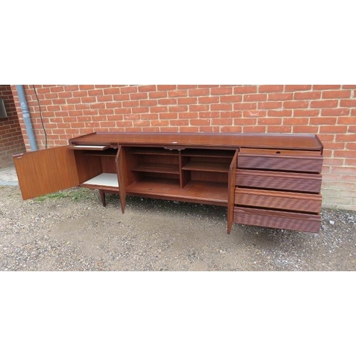 710 - A mid-century solid Afromosia teak sideboard by Richard Hornby for Heal’s, housing three cupboards w... 