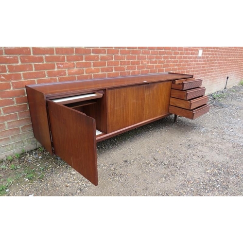 710 - A mid-century solid Afromosia teak sideboard by Richard Hornby for Heal’s, housing three cupboards w... 