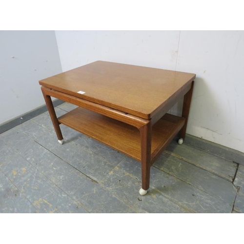 713 - A mid-century Danish solid teak two-tier coffee table by France & son, having blind frieze drawer to... 