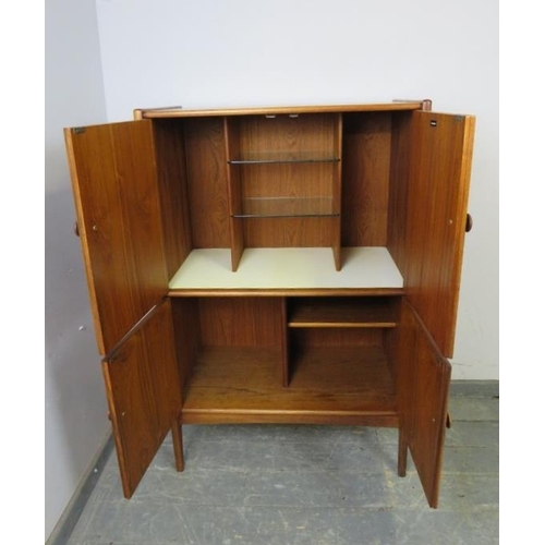 714 - A mid-century teak drinks cabinet by Younger, the double doors opening to reveal a fitted interior w... 