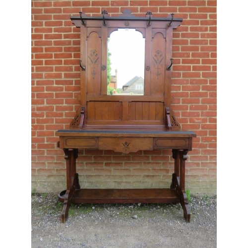 718 - An Arts & Crafts Period walnut hallstand in the manner of Pugin, the mirror back flanked by six gilt... 