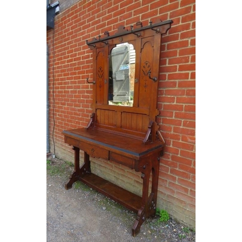 718 - An Arts & Crafts Period walnut hallstand in the manner of Pugin, the mirror back flanked by six gilt... 