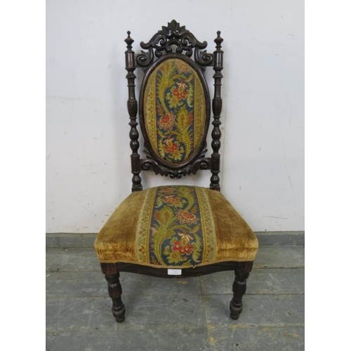 722 - A 19th century bedroom chair, the carved back with turned finials, upholstered in a tapestry and gol... 