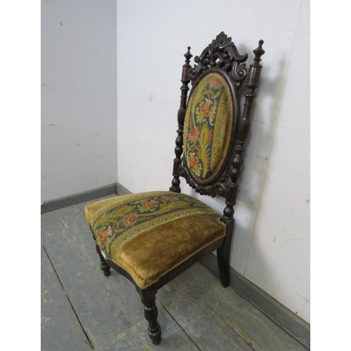 722 - A 19th century bedroom chair, the carved back with turned finials, upholstered in a tapestry and gol... 