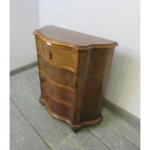 723 - An antique burr walnut serpentine fronted side cabinet of small and narrow proportions, housing one ... 