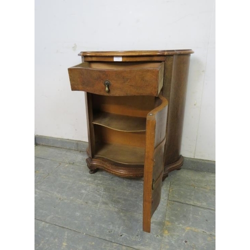 723 - An antique burr walnut serpentine fronted side cabinet of small and narrow proportions, housing one ... 