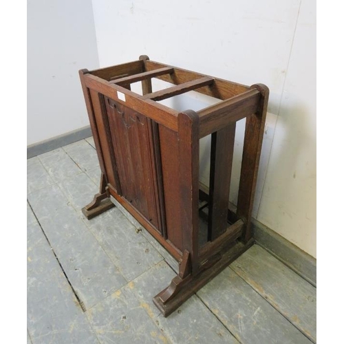 725 - An early 20th century oak stick stand, having three divided compartments, the front with linen fold ... 