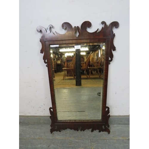 729 - A Georgian rectangular bevelled wall mirror, within a parcel gilt and shaped mahogany surround. 
H85... 