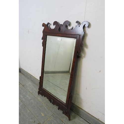 729 - A Georgian rectangular bevelled wall mirror, within a parcel gilt and shaped mahogany surround. 
H85... 