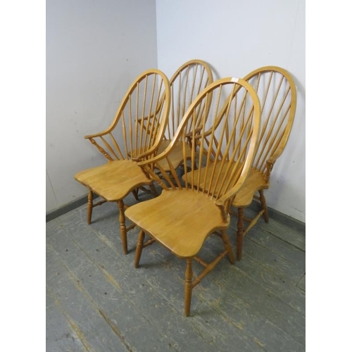 731 - A set of four beech Windsor style carver chairs, the hoop backs with turned spindles, above shaped s... 