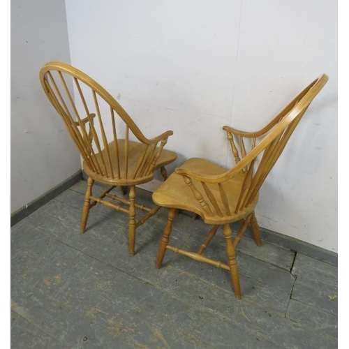 731 - A set of four beech Windsor style carver chairs, the hoop backs with turned spindles, above shaped s... 